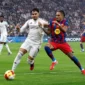 Duel Raul Asencio dan Raphinha dalam laga Barcelona vs Real Madrid saat Final Piala Super Spanyol 2026 di King Abdullah Sports City Stadium, Jeddah, Arab Saudi, pada Senin (12/1) dini hari WIB.