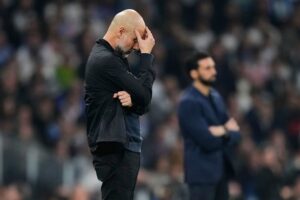 Reaksi pelatih Manchester City, Pep Guardiola usai kalah kalah melawan Real Madrid di leg 1 babak 16 besar Liga Champions, 12 Maret 2026 di Bernabeu. (c) Foto AP/Jose Breton